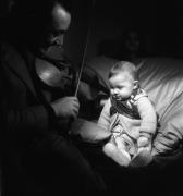 Django Reinhardt joue du violon à son fils Babik à l'âge de huit mois, Paris, 1945